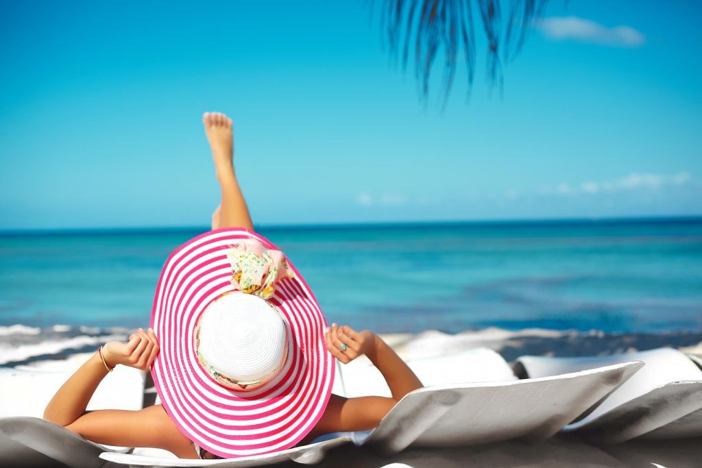 beautiful-woman-model-sunbathing-beach-chair-white-bikini-colorful-sunhat-blue-summer-water-ocean.jpg